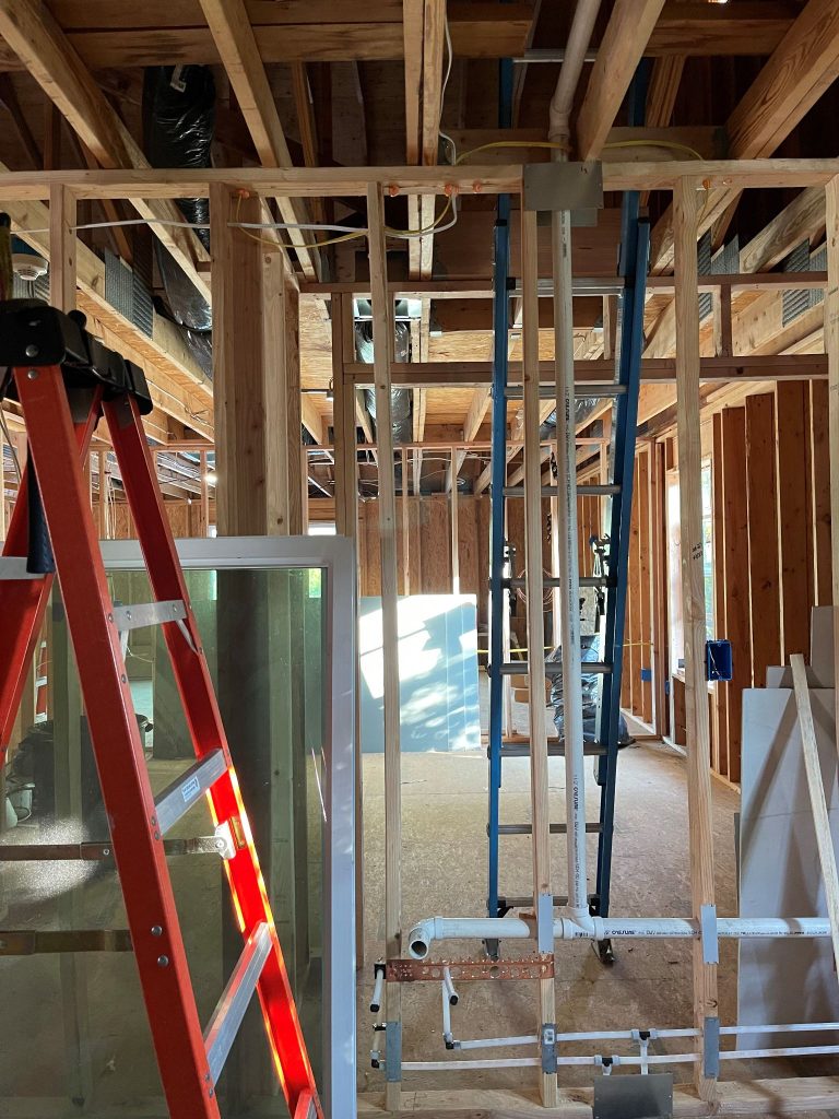 multiple ladders in a room getting electric work done